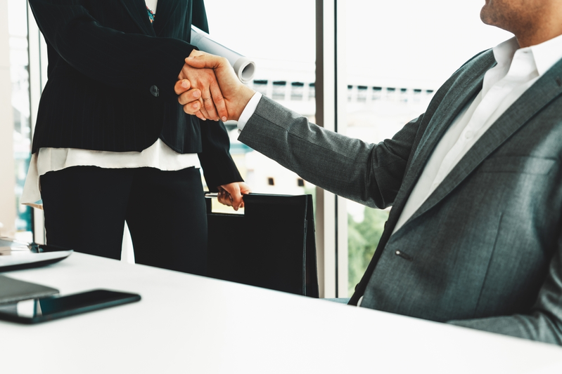 two people shaking hands during a business meeting